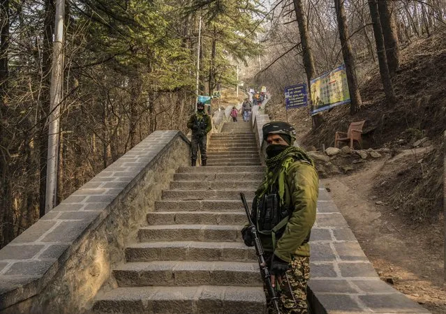 Indian paramilitary soldiers guard outside Shankaracharya temple in Srinagar, Indian controlled Kashmir, during the inauguration of newly-built Lord Ram temple in Ayodhya, Monday, January 22, 2024. Indian Prime Minister Narendra Modi on Monday opened a controversial Hindu temple built on the ruins of a historic mosque in the holy city of Ayodhya in a grand event that is expected to galvanize Hindu voters in upcoming elections. (Photo by Mukhtar Khan/AP Photo)