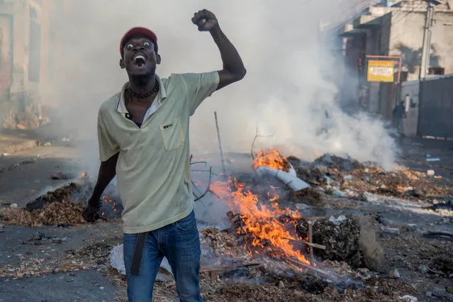 People participate in a protest in Port-au-Prince, Haiti, 09 February 2019. Tension remains high in Haiti after the massive protest held on 07 February against the country's president, Jovenel Moise, and mobilizations called by the opposition continue despite the call for calm and dialogue by the president. (Photo by Jean Marc Herve Abelard/EPA/EFE)