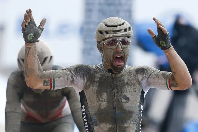 Sonny Colbrelli of Italy celebrates as he crosses the finish line ahead of Florain Vermeersch of Belgium, rear and second place, to win the men's Paris Roubaix, a 258 kilometer (160.3 miles) one-day-race cycling race, at the velodrome in Roubaix, northern France, Sunday, October 3, 2021. (Photo by Michel Spingler/AP Photo)