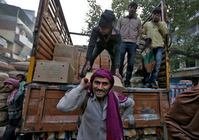Porters move goods in the Chandni Chowk area of Old Delhi, India February 1, 2017. (Photo by Cathal McNaughton/Reuters)
