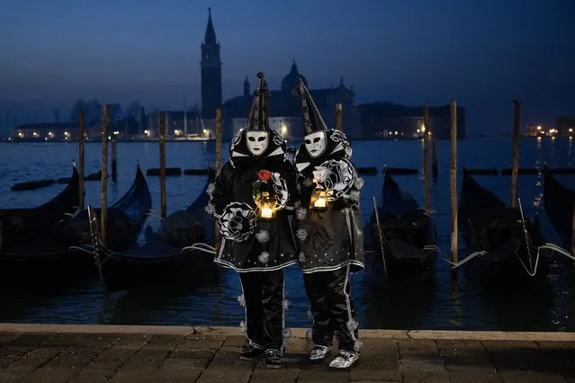 Masked revellers wearing period costumes pose during the traditional Venice Carnival, on February 4, 2024. (Photo by Marco Bertorello/AFP Photo)