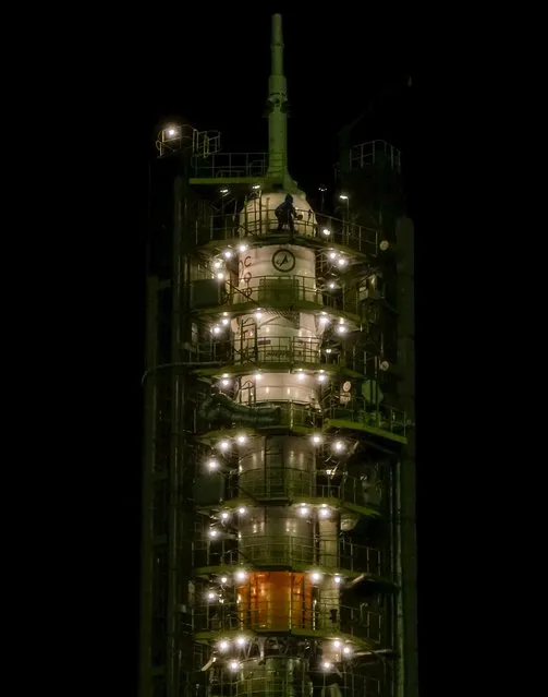 A specialist works on the Soyuz TMA-20M for the next International Space Station (ISS) crew of Jeff Williams of the U.S. and Oleg Skriprochka and Alexey Ovchinin of Russia after it is lifted at the launchpad ahead of its launch scheduled on March 19 at the Baikonur cosmodrome, Kazakhstan, March 16, 2016. (Photo by Shamil Zhumatov/Reuters)