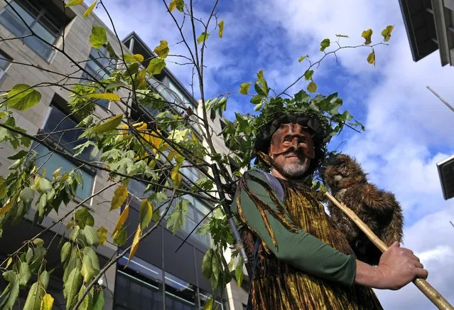 An Extension Rebellion activist dressed as a tree takes part in a demonstration near the COP26 U.N. Climate Summit in Glasgow, Scotland, Wednesday, November 3, 2021. The U.N. climate summit in Glasgow gathers leaders from around the world, in Scotland's biggest city, to lay out their vision for addressing the common challenge of global warming. (Photo by Alastair Grant/AP Photo)