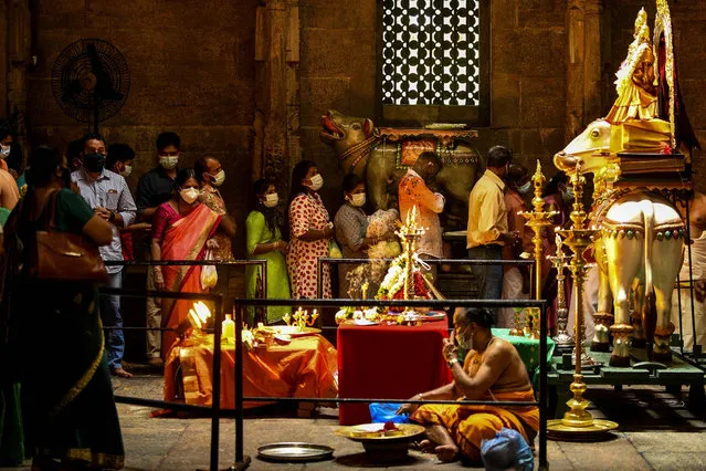 Hindu devotees gather at a temple to offer prayers during Diwali, the festival of lights, in Colombo on November 4,2021. (Photo by Ishara S Kodikara/AFP Photo)