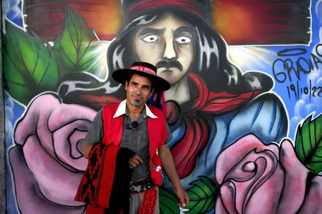 Carlos Maiana poses for a picture in front of a mural depicting folk Saint “Gauchito” Gil during his visit to his sanctuary in Mercedes Corrientes, Argentina, Saturday, January 6, 2024. (Photo by Natacha Pisarenko/AP Photo)