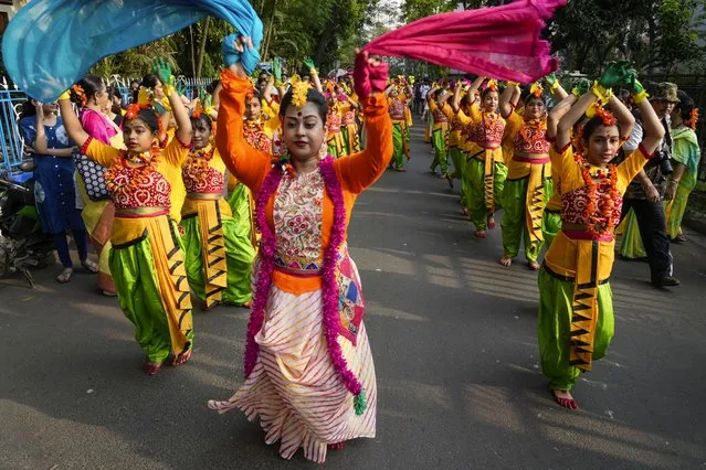 Women dance on a street while taking part in a procession to celebrate Holi, the festival of colors, in Kolkata, India, Monday, March 25, 2024. (Photo by Bikas Das/AP Photo)