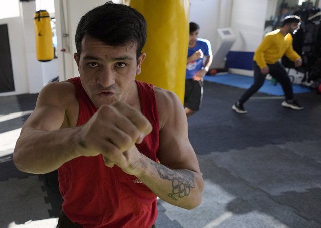 A member of the Afghan national boxing team trains during a session in local gym in Serbia, Wednesday, December 1, 2021. They practiced in secrecy and sneaked out of Afghanistan to be able to compete at an international championship. Now, the Afghan boxing team are seeking refuge in the West to be able to continue both their careers and lives without danger or fear. (Photo by Darko Vojinovic/AP Photo)