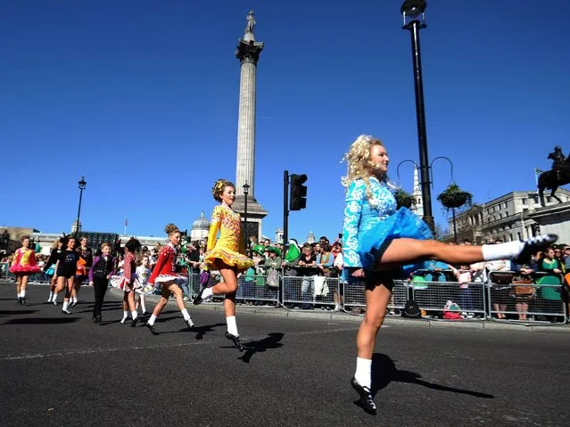 Dancers dressed in Irish themed costumes participate in the annual St. Patrick's Day Festival as it passes from Piccadilly to Trafalgar Square through Haymarket. (Photo by PA Wire)