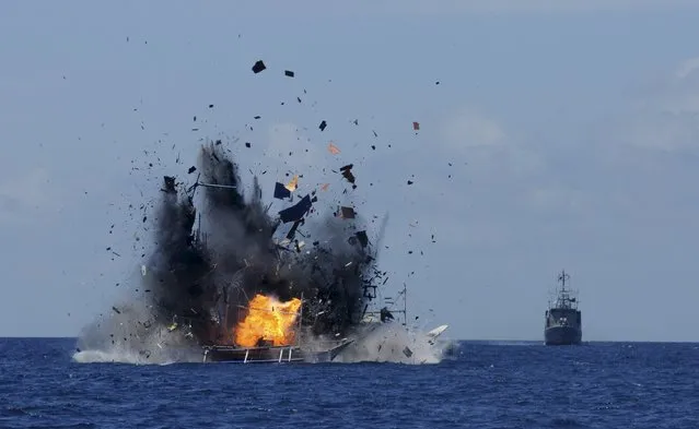 The Indonesian navy scuttles foreign fishing vessels caught fishing illegally in Indonesian waters near Bitung, North Sulawesi May 20, 2015 in the is photo taken by Antara Foto. A total of 19 foreign boats from Vietnam, Thailand, Philippines and one from China were destroyed near Bitung as part of an ongoing crackdown by the Indonesian government on illegal fishing. (Photo by Fiqman Sunandar/Reuters/Antara Foto)