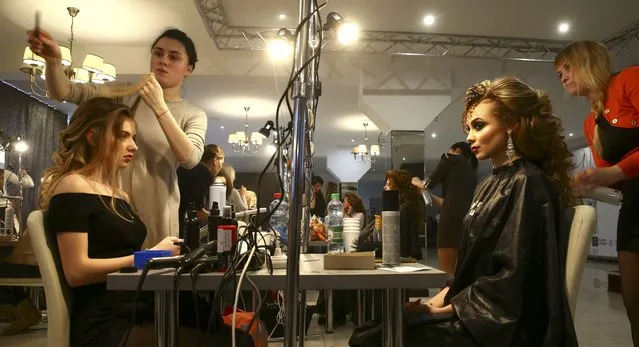 Models are having hair done backstage during the “Best Hairstyle 2017” competition in Minsk, Belarus February 24, 2017. (Photo by Vasily Fedosenko/Reuters)