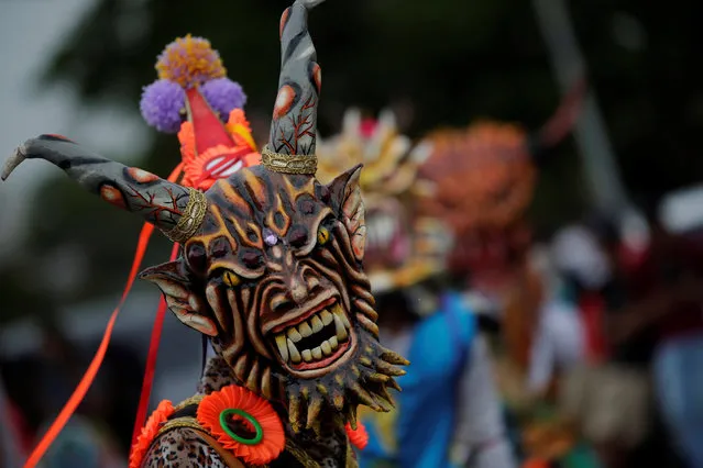 People wearing costumes of devils dance during the celebration of the Corpus Christi in the streets of La Chorrera, Panama, 23 June 2019. Corpus Christi is a celebration of the catholic church destined to celebrate the Eucharist, and aims to increase the faith of believers. (Photo by Bienvenido Velasco/EPA/EFE)