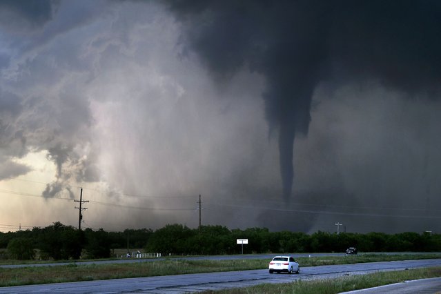 A tornado spins west of Hawley, Texas, as cars pass on U.S. 277 on Thursday May 2, 2024. (Photo by Ronald W. Erdrich/The Abilene Reporter-News via AP Photo)