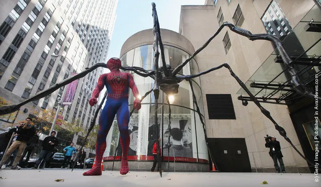 Spider-Man: Turn Off the Dark actor Craig Henningsen walks beneath the 21-foot wide 'Spider' sculpture by artist Louise Bourgeois