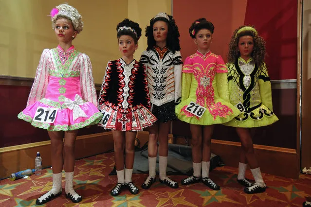 Competitors in the 11/12 Girls Ceili Category wait to perform backstage at the World Irish Dance Championship on April 13, 2014 in London, England. The 44th World Irish Dance Championship is currently running at London's Hilton London Metropole hotel, and will host approximately 5,000 dancers competing in solo, Ceili, modern figure choreography and dance drama categories during the week long event. (Photo by Dan Kitwood/Getty Images)