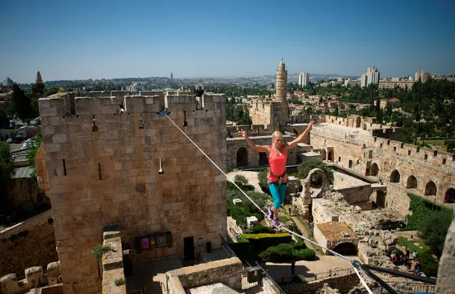American slackliner Heather Larsen crosses a high wire between two towers at the Tower of David Museum in Jerusalem's Old City May 2, 2016. (Photo by Nir Elias/Reuters)