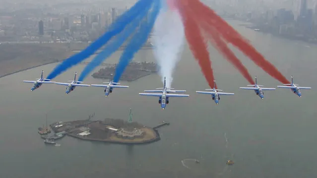 This handout framegrab taken by the French Air Force shows La Patrouille de France alphajets flying over the Statue of Liberty, as part of a 6-week tour of the US, on March 25, 2017, in New York. The tour celebrates the 100th anniversary of America's April 6, 1917, entry in World War I. (Photo by AFP Photo/French Air Force)