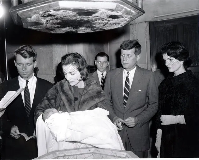 Sen. John Kennedy, D-Mass., and his wife, Jacqueline Kennedy, watch as her sister, Mrs. Lee Bouvier Canfield,  holds their 15-day-old daughter during her christening in St. Patrick's Cathedral in New York City on December 13, 1957.  At left is the senator's brother, Robert Kennedy, acting as godfather.  Third from left is Stephen Smith, the senator's brother-in-law.  Boston's archbishop Richard Cushing christened the baby, named Caroline. (Photo by AP Photo)