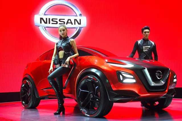 South Korean models pose with Nissan Gripz Concept car during a press preview of the Seoul Motor Show in Goyang, northwest of Seoul, on March 30, 2017. (Photo by Jung Yeon-Je/AFP Photo)