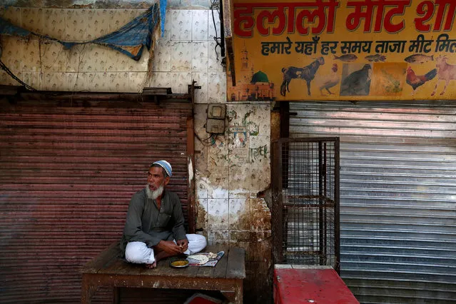 A muslim meat shop owner looks on outside his closed shop in Gurugram, Haryana, March 29, 2017. (Photo by Cathal McNaughton/Reuters)