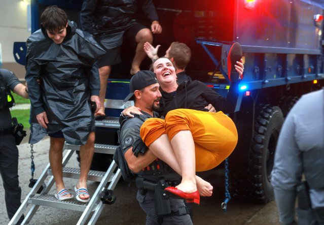 A City of Hollywood SWAT team member helps Alex Treacy from a search and rescue truck as she is evacuated from a flooded area on June 12, 2024, in Hollywood, Florida. As tropical moisture passes through the area, areas have become flooded due to the heavy rain. (Photo by Joe Raedle/Getty Images)