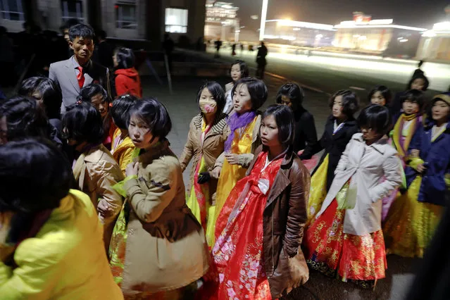 Women dressed in traditional costumes walk near the main Kim Il Sung square in central Pyongyang, North Korea April 11, 2017. (Photo by Damir Sagolj/Reuters)