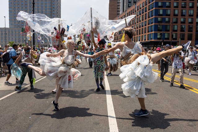 People raising awareness about plastic ocean pollution dance while participating in the Mermaid Parade during a heatwave in Coney Island, area of Brookly, New York City, U.S., June 22, 2024. (Photo by Caitlin Ochs/Reuters)