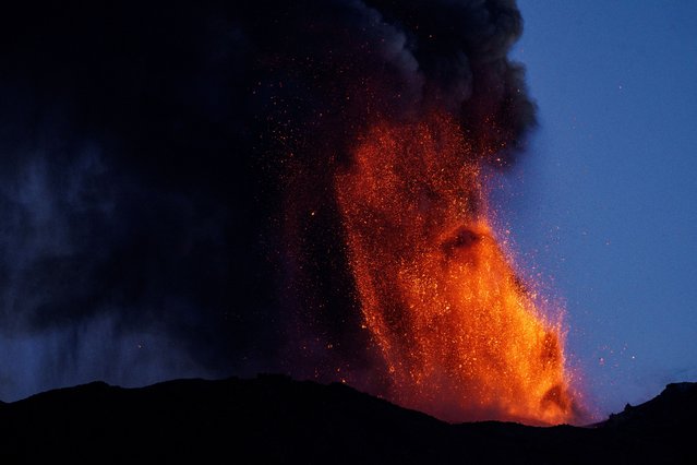 Lava and smoke rise from a crater of Mount Etna, Europe's most active volcano, Italy on July 4, 2024. (Photo by Giuseppe Di Stefano/Etna Walk via Reuters)