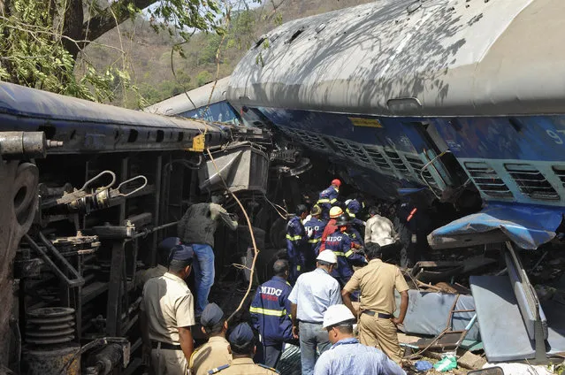 Rescuers search for survivors from the debris of a passenger train after it derailed near Nidi village in the western Indian state of Maharashtra May 4, 2014. At least 13 passengers were killed and 30 others injured when four bogies of a passenger train derailed near the village on Sunday, railway officials said. (Photo by Reuters)