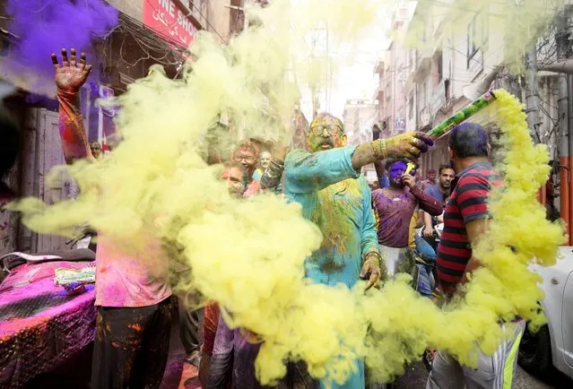 People celebrate Holi in Jammu, India, Friday, March 18, 2022. Holi, the Hindu festival of colors, also heralds the arrival of spring. (Photo by Channi Anand/AP Photo)