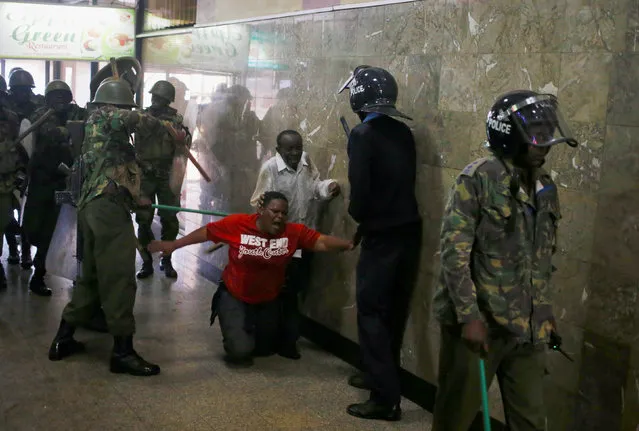 Kenyan policemen beat protesters during clashes in Nairobi, Kenya May 16, 2016. (Photo by Goran Tomasevic/Reuters)