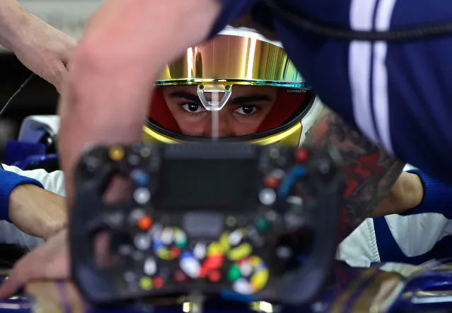 Sauber driver Pascal Wehrlein of Germany is helped getting into his car cockpit during the second practice session ahead the Formula One Russian Grand Prix at the “Sochi Autodrom” circuit, in Sochi, Russia, Friday, April 28, 2017. The Russian Formula One Grand Prix will be held on Sunday. (Photo by Sergei Grits/AP Photo)