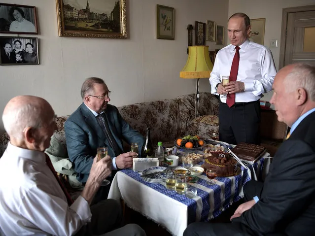 Russian President Vladimir Putin, second right, makes a toast to congratulate former head of the KGB intelligence group in Dresden, Germany, Lazar Matveyev, left, on his 90th birthday on the eve of Victory Day, in Zhulebino in Moscow, Russia, Monday, May 8, 2017. Matveyev, former KGB representative at the Ministry of State Security of the German Democratic Republic, who was Vladimir Putin's supervisor in Dresden in the second half of the 1980's. (Photo by Alexei Nikolsky, Sputnik, Kremlin Pool Photo via AP Photo)