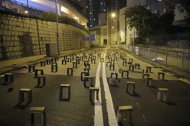 Bricks are set by pro-democracy protesters outside the campus of the University of Hong Kong, early Thursday, November 14, 2019. University students from mainland China and Taiwan are fleeing Hong Kong, while those from three Scandinavian countries have been moved or urged to leave as college campuses become the latest battleground in the city's 5-month-long anti-government unrest. (Photo by Kin Cheung/AP Photo)