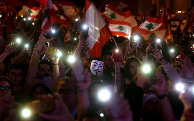 Lebanese demonstrators take part in a civilian Independence Day parade in Beirut's Martyr Square on November 22, 2019, more than a month into protests demanding an overhaul of the entire political system. Lebanese celebrated 76 years of national self-rule Friday, tens of thousands massing for joyous street festivities rather than stiff military parades to hail what a new protest movement calls “real independence”. (Photo by Patrick Baz/AFP Photo)