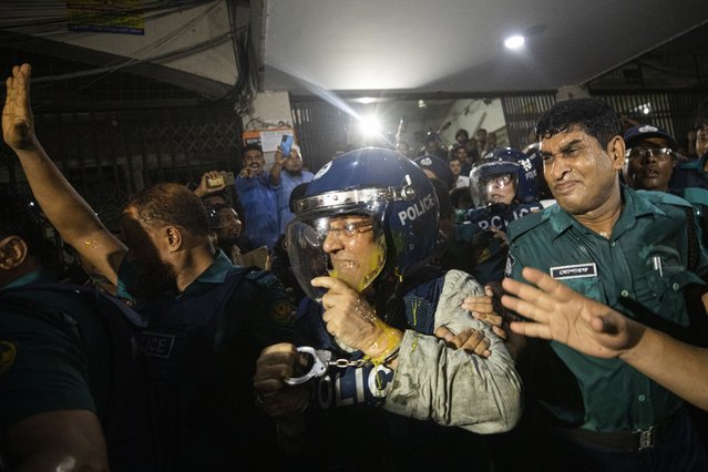 Policemen escort former law minister Anisul Huq, center, to the court of the Chief Metropolitan Magistrate in Dhaka, Bangladesh, Wednesday, August 14, 2024. (Photo by Rajib Dhar/AP Photo)