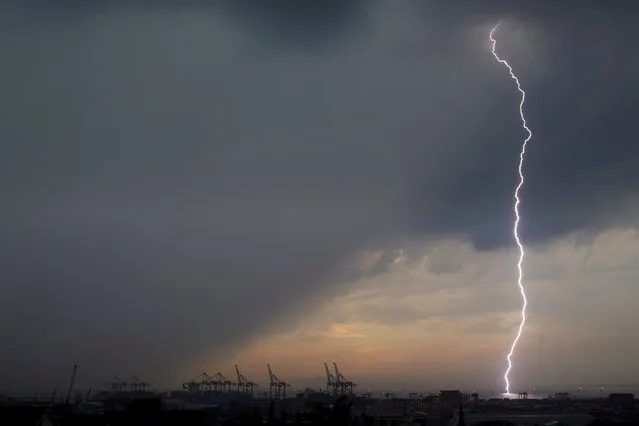 A bolt of lightning strikes over harbour cranes in Cape Town, South Africa, April 26, 2017. (Photo by Mike Hutchings/Reuters)