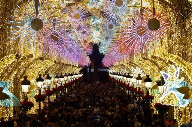 People gather at Marques de Larios street, decorated with Christmas lights, in downtown Malaga, southern Spain, November 29, 2019. (Photo by Jon Nazca/Reuters)