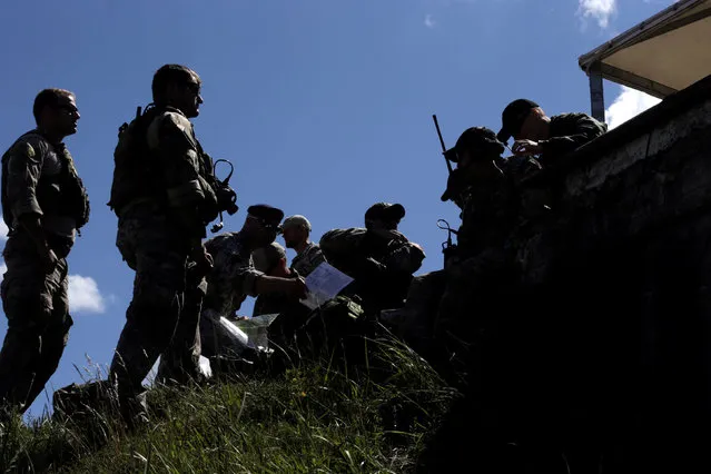U.S. army personal take part in the “Saber Strike” NATO military exercise in Adazi, Latvia, June 13, 2016. (Photo by Ints Kalnins/Reuters)