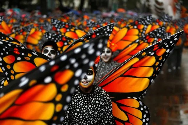 Participants dressed as Monarch butterflies perform during the annual Day of the Dead parade in Mexico City, Mexico, October 27, 2019. (Photo by Gustavo Graf/Reuters)