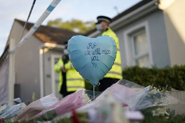 A balloon and floral tributes are placed on the road leading to the Belfairs Methodist Church in Eastwood Road North, in Leigh-on-Sea, Essex, England, Saturday, October 16, 2021. David Amess, a long-serving member of Parliament was stabbed to death during a meeting with constituents at a church in Leigh-on-Sea on Friday, in what police said was a terrorist incident. A 25-year-old man was arrested in connection with the attack, which united Britain's fractious politicians in shock and sorrow. (Photo by Alberto Pezzali/AP Photo)