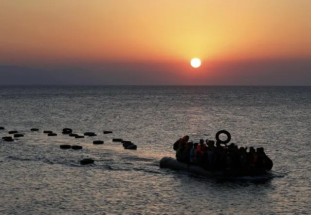 A dinghy overcrowded with Syrian refugees approaches a beach on the Greek island of Kos after crossing a part of the Aegean sea from Turkey to Greece, August 13, 2015. (Photo by Yannis Behrakis/Reuters)