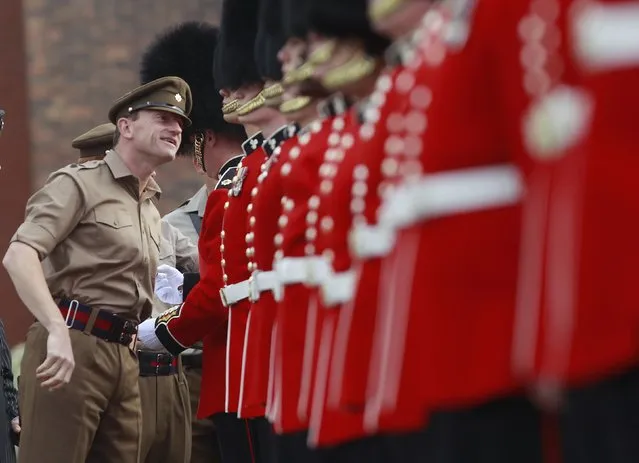 Lieutenant Colonel Christopher Ghika, Commanding Officer of the 1st Battalion Irish Guards, inspects his men in the parade ground of their barracks in southern England. (Photo by Eddie Keogh/Reuters)