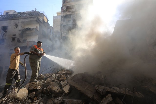 Members of the Lebanese civil defence battle a fire at the site of an Israeli strike on Beirut's Basta neighbourhood on October 11, 2024. At least 22 people were killed in Israeli strikes on a densely populated area of central Beirut on October 10, the Lebanese health ministry said, with a security source saying a Hezbollah figure was the target. (Photo by AFP Photo/Stringer)