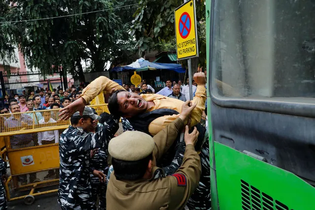 Police detains an activist of the youth wing of India's main opposition Congress party during a protest demanding the resignation of Home Minister Amit Shah following last week's clashes between people demonstrating for and against a new citizenship law in New Delhi, India March 2, 2020. (Photo by Anushree Fadnavis/Reuters)