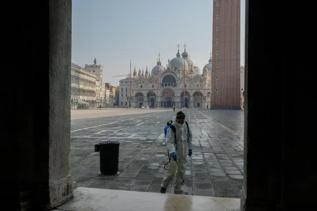 A worker sanitises St. Mark's square as a measure to fight against the coronavirus contagion in Venice, Italy, March 12, 2020. (Photo by Manuel Silvestri/Reuters)