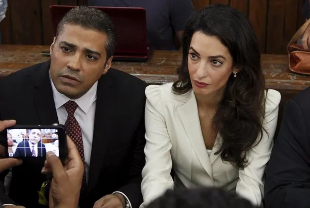 Al Jazeera television journalist Mohamed Fahmy and his lawyer Amal Clooney look on, before hearing the verdict at a court in Cairo, Egypt, August 29, 2015. An Egyptian court sentenced three Al Jazeera TV journalists to three years in prison on Saturday for operating without a press licence and broadcasting material harmful to Egypt, a case that has triggered an international outcry. (Photo by Asmaa Waguih/Reuters)