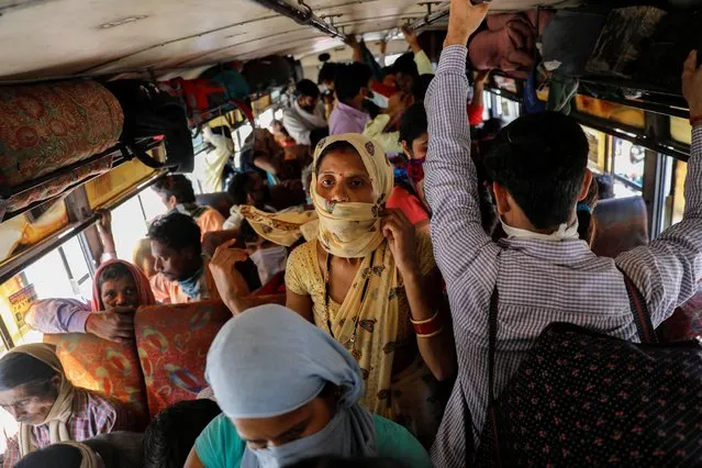 Migrant workers are seen in a bus arranged by Uttar Pradesh state government to transport the people stranded in Ghaziabad, on the outskirts of New Delhi, India March 28, 2020. (Photo by Anushree Fadnavis/Reuters)