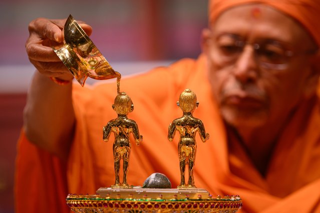 Swami Tyagvallabhdas bathes Shri Akshar-Purushottam Maharaj in the ritual of Sharda Pujan during Diwali celebrations at Neasden Temple, also known as BAPS Shri Swaminarayan Mandir, on November 12, 2023 in the Neasden area of London, England. Diwali (also known as Deepavali) is the Hindu festival of lights celebrated each autumn. (Photo by Leon Neal/Getty Images)