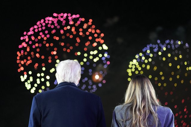 US President-elect Donald Trump and his wife Melania Trump watch fireworks during a reception in his honor at Trump National Golf Club Washington DC in Sterling, Virginia, on January 18, 2025. (Photo by Alex Brandon/Pool via AFP Photo)