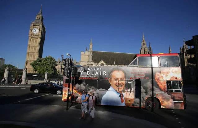 A london bus with an advertisment for a film about former British Prime Minister Tony Blair passes near the Houses of Parliament in central London on July 18, 2016. Prime Minister Theresa May warned Monday that the threat from nuclear weapons was increasing as she pressed MPs to approve the replacement of the ageing submarines that carry Britain's nuclear arsenal. MPs will vote Monday evening on whether to approve the construction of four new submarines to carry the Trident missile system and their nuclear warheads, at a cost of £41 billion (49 billion euros, $54 billion). (Photo by Daniel Leal-Olivas/AFP Photo)